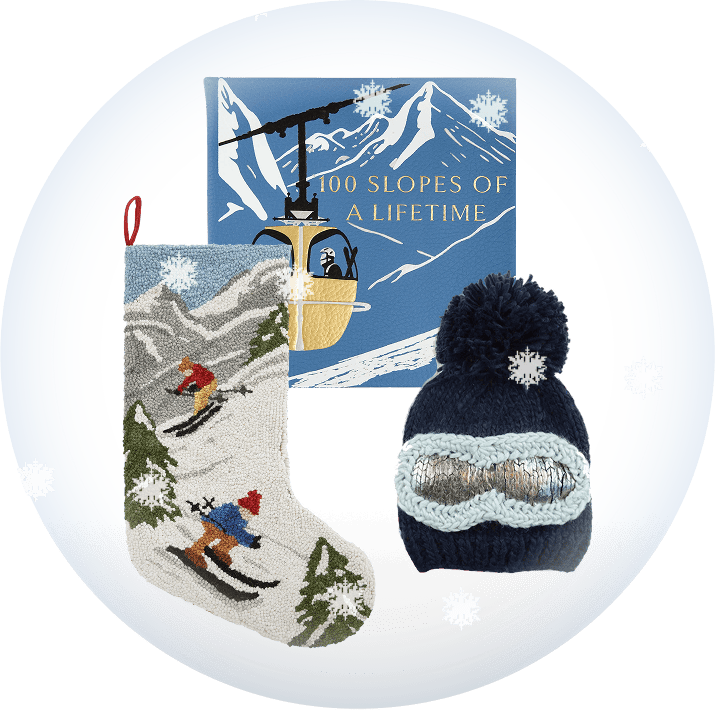 Book entitled "100 Slopes of a Lifetime," with ski-themed stocking and ski hat on a transparent background with snow.