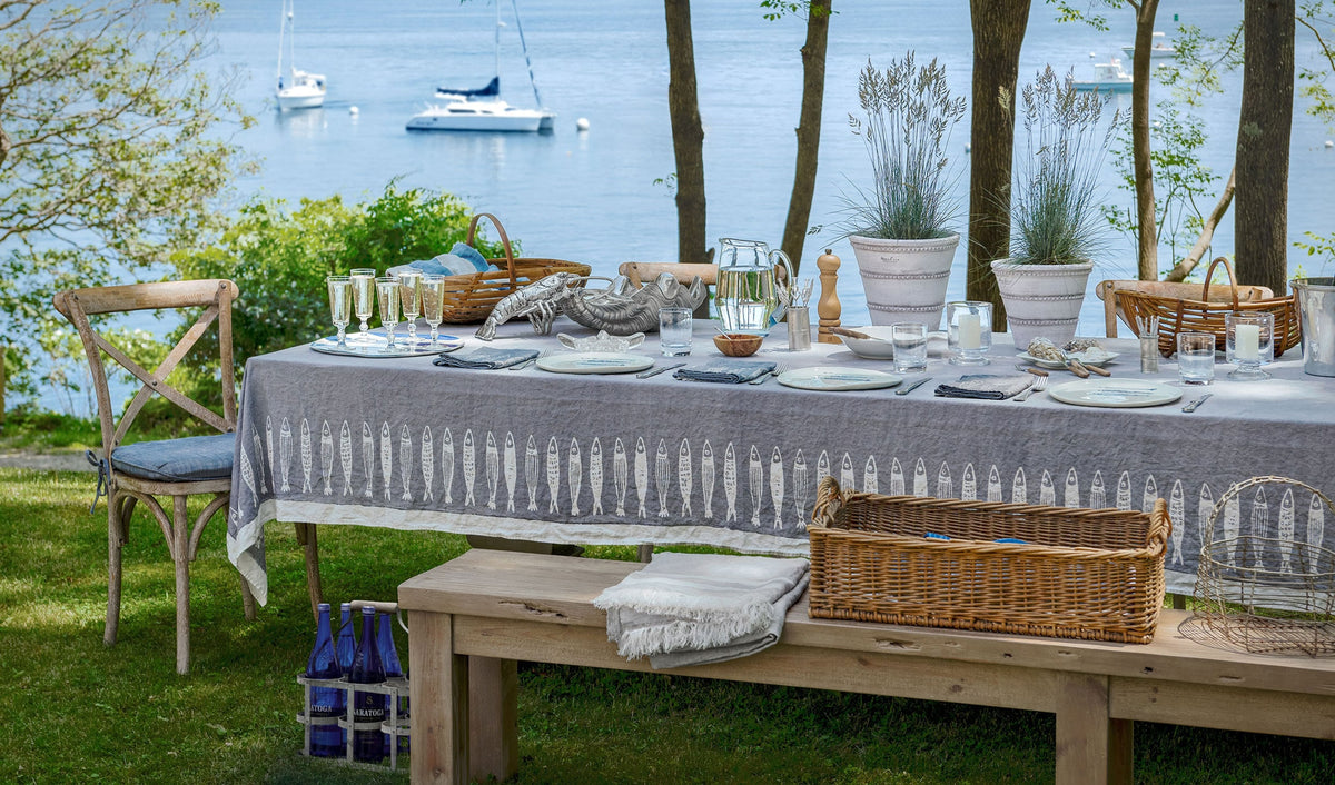 Dining table set for a meal with a view of boats on the water