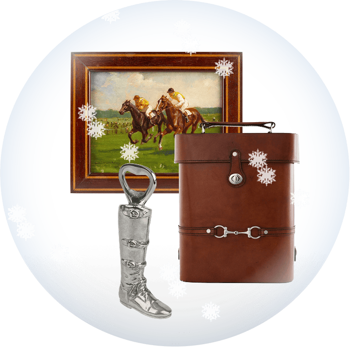 Brown leather wine carrier bag with silver accents, equestrian boot bottle opener, and framed artwork of two people on horseback.