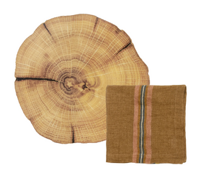  Folded brown napkin with striped pattern laid over a woodland placemat 