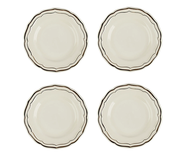 Set of four ceramic plates with decorative edges on a white background