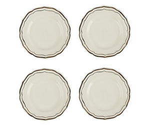  Set of four ceramic plates with decorative edges on a white background 