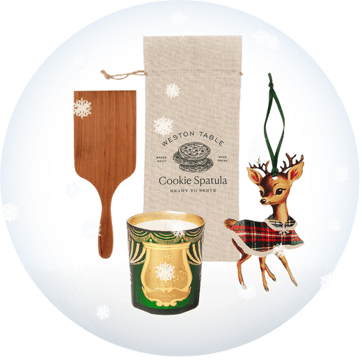 Cookie spatula, candle, and decorative deer ornament on a transparent background with snow.