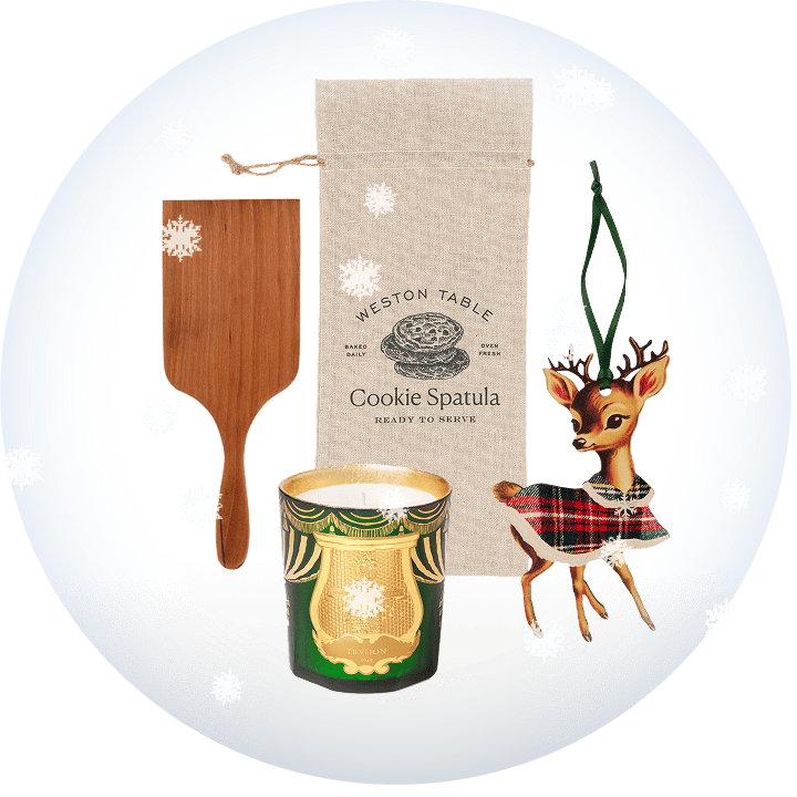 Cookie spatula, candle, and decorative deer ornament on a transparent background with snow.