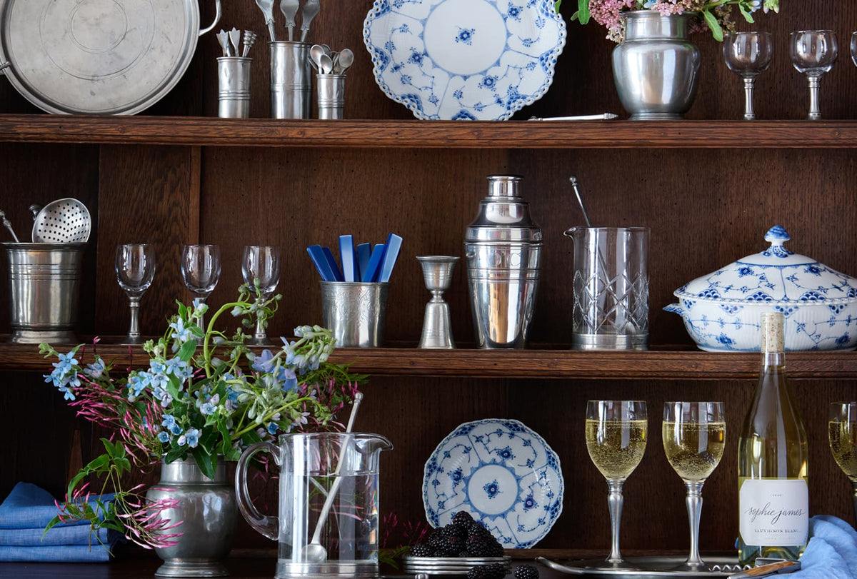 Shelves with decorative items including plates, glasses, and a bottle of wine.