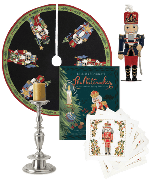  Collage of Christmas-themed items including a nutcracker tree skirt, figurine, book, and embroidered cocktail napkins, and a MATCH Pewter candlestick. 