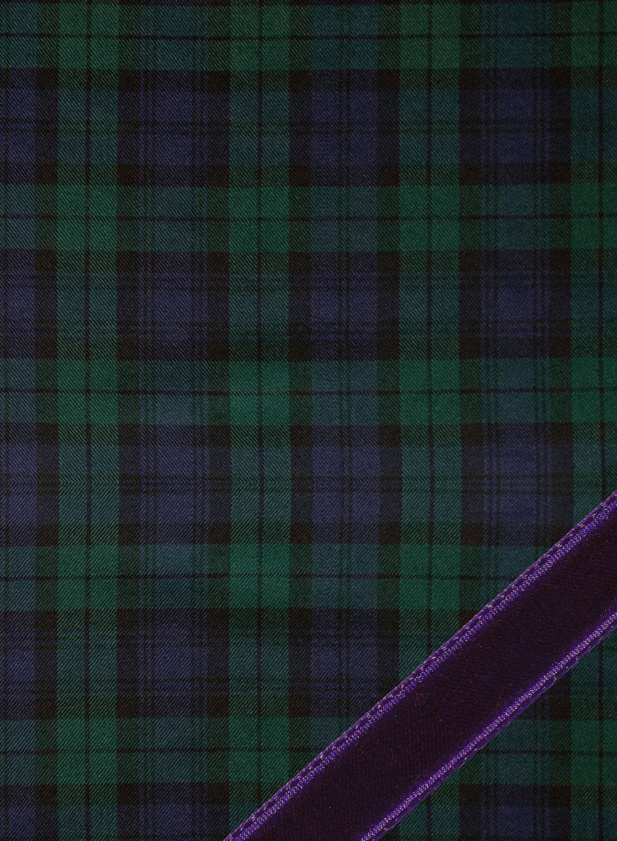 A close-up of a tartan plaid fabric pattern in dark green and deep blue, with a diagonal purple ribbon or trim running across the lower right corner. Weston Table.