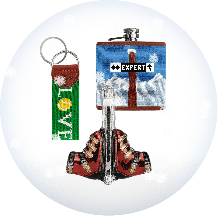Flask and keychain set with ski boot ornament on a transparent background with snow.