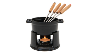  Black fondue pot with four skewers on a white background 